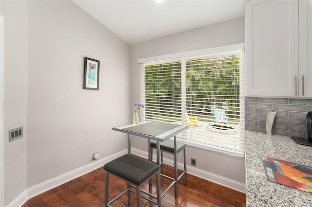 3268 Tanglewood Trl, Palm Harbor, FL 34685 - home office with dark wood-type flooring, baseboards, and vaulted ceiling