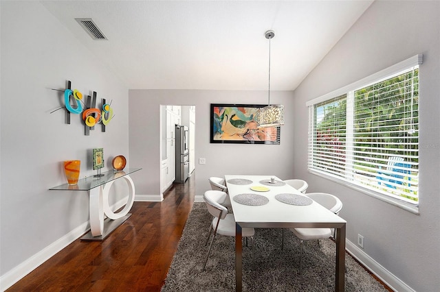 3268 Tanglewood Trl, Palm Harbor, FL 34685 - dining space featuring wood finished floors, baseboards, and vaulted ceiling