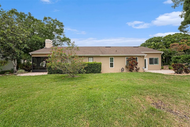 3268 Tanglewood Trl, Palm Harbor, FL 34685 - rear view of house featuring a sunroom, a chimney, a lawn, and stucco siding