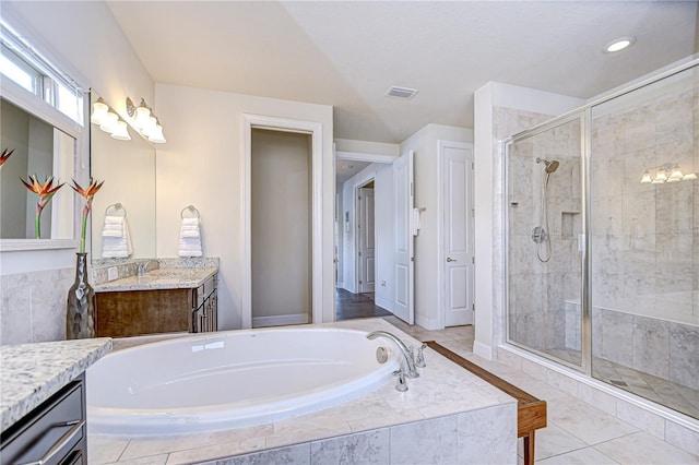 bathroom with a stall shower, a garden tub, vanity, baseboards, and recessed lighting