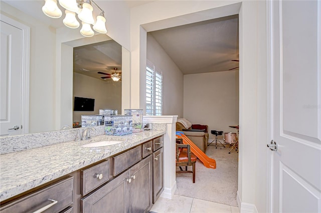 bathroom with ceiling fan, tile patterned flooring, vanity, and a chandelier