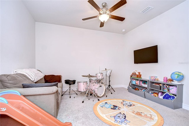 playroom with carpet flooring, ceiling fan, and baseboards