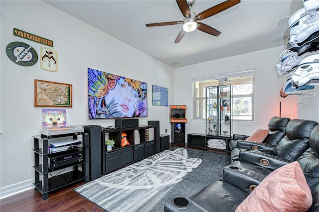 living room featuring dark wood-type flooring, a ceiling fan, and baseboards