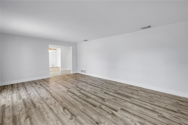 unfurnished room featuring wood finished floors and baseboards