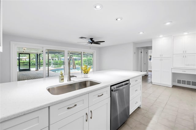 kitchen with dishwasher, a sink, ceiling fan, white cabinetry, and recessed lighting