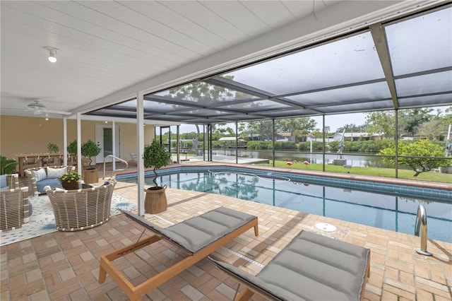swimming pool with a water view, outdoor lounge area, a patio, and a lanai