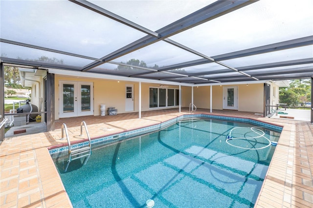 outdoor pool featuring french doors, a patio area, and glass enclosure