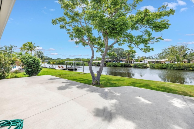 view of patio / terrace with a water view, a dock, and boat lift