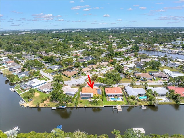 aerial view of property's location featuring a large body of water and nearby suburban area