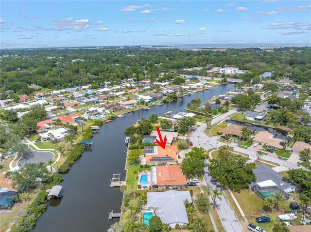 aerial view of property and surrounding area with a large body of water and nearby suburban area