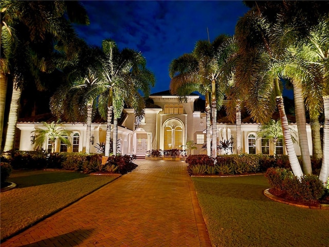 mediterranean / spanish house featuring decorative driveway and stucco siding