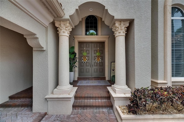 property entrance featuring stucco siding