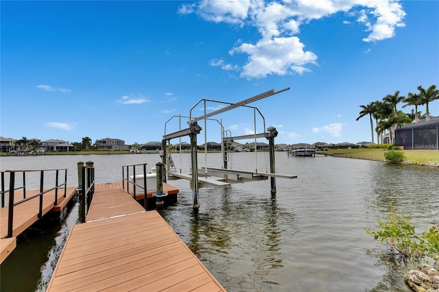 dock featuring boat lift, a water view, and a residential view