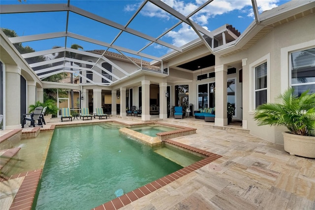 view of pool with a patio area, a pool with connected hot tub, and glass enclosure