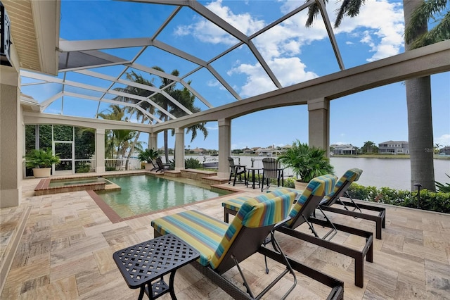 view of swimming pool with a patio area, a water view, glass enclosure, and a pool with connected hot tub