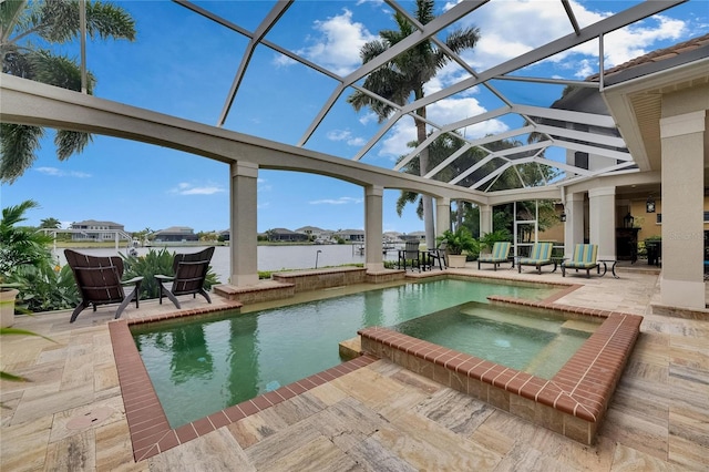 view of swimming pool with a patio, glass enclosure, a pool with connected hot tub, and a water view