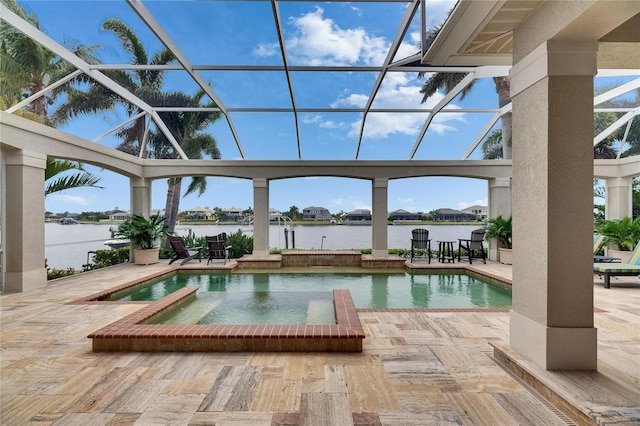 outdoor pool featuring a patio area, a water view, and a lanai