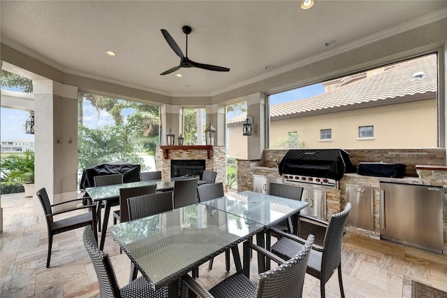 view of patio with outdoor dining space, area for grilling, a ceiling fan, and grilling area