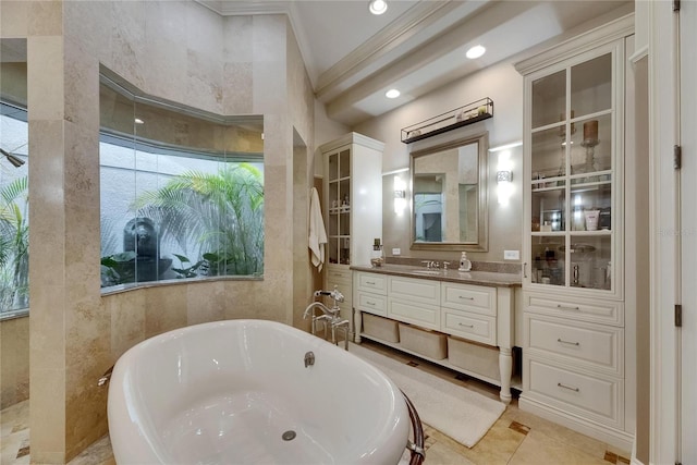 full bathroom featuring a freestanding bath, crown molding, vanity, and recessed lighting