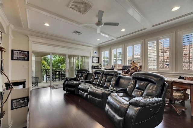 cinema room featuring a ceiling fan, coffered ceiling, crown molding, dark wood-type flooring, and beam ceiling