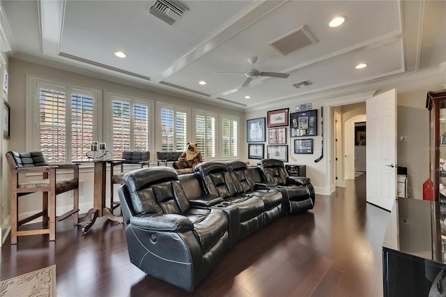 cinema with ornamental molding, ceiling fan, dark wood-style flooring, arched walkways, and recessed lighting