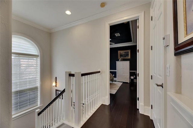 corridor featuring an upstairs landing, dark wood finished floors, crown molding, and recessed lighting