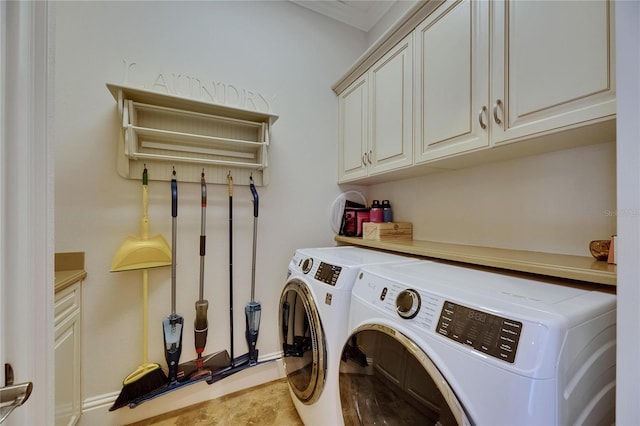 clothes washing area with cabinet space, washer and dryer, and baseboards