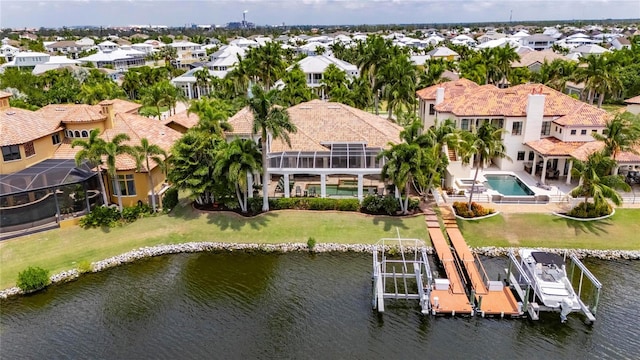 aerial perspective of suburban area featuring a large body of water and a pool area