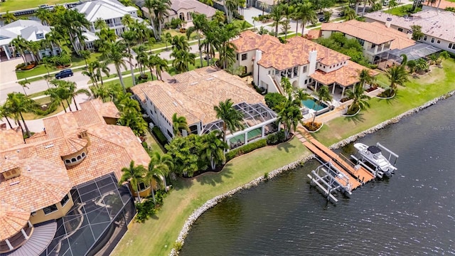 aerial view of residential area featuring a large body of water