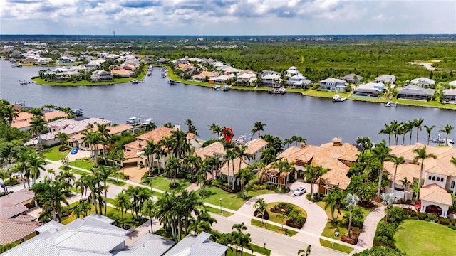 aerial view of residential area featuring a large body of water