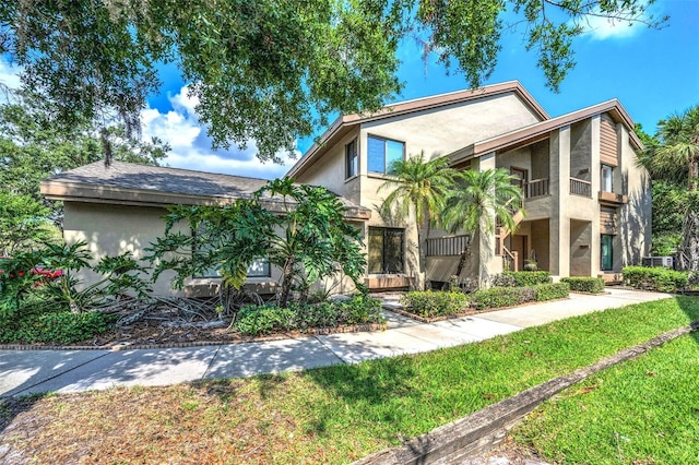 3079 Landmark Blvd Unit 1608, Palm Harbor, FL 34684 - view of front of home with stucco siding and a front lawn