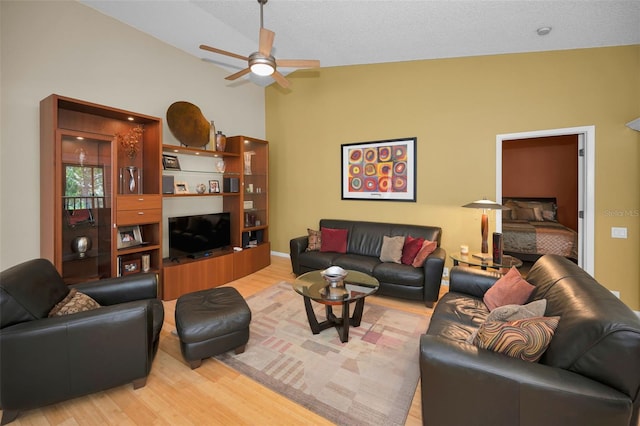 3079 Landmark Blvd Unit 1608, Palm Harbor, FL 34684 - living area with light wood finished floors, a ceiling fan, lofted ceiling, and baseboards
