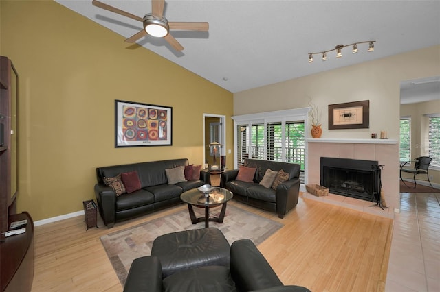 3079 Landmark Blvd Unit 1608, Palm Harbor, FL 34684 - living area featuring ceiling fan, a fireplace, high vaulted ceiling, baseboards, and light wood-style flooring