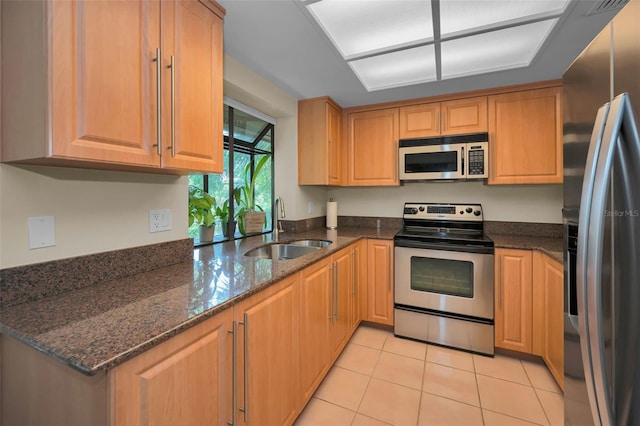 3079 Landmark Blvd Unit 1608, Palm Harbor, FL 34684 - kitchen featuring stainless steel appliances, a sink, dark stone counters, and light tile patterned floors