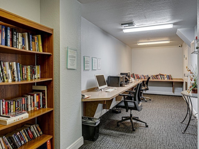carpeted office featuring a textured wall, a textured ceiling, and baseboards