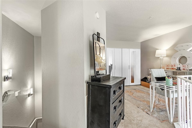 kitchen featuring light colored carpet, dark countertops, and dark cabinets