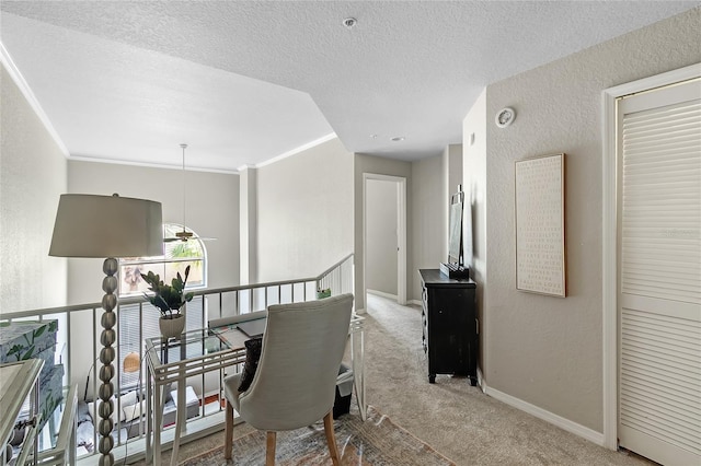 corridor with carpet flooring, a textured wall, baseboards, a textured ceiling, and an upstairs landing