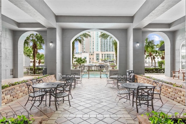 view of patio / terrace featuring a community pool and outdoor dining space