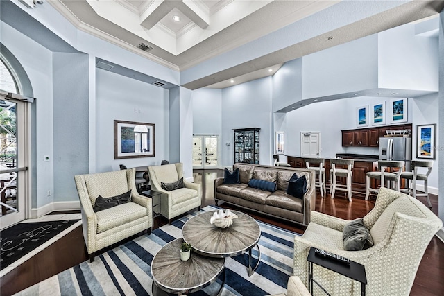 living area with a high ceiling, crown molding, baseboards, dark wood-style floors, and coffered ceiling