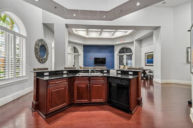 kitchen featuring dishwasher, a sink, reddish brown cabinets, open floor plan, and baseboards