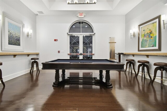 game room with hardwood / wood-style flooring, billiards, and a raised ceiling