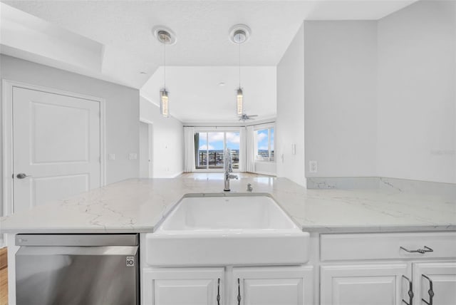 kitchen with white cabinetry, light stone counters, a sink, and dishwasher