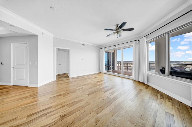 unfurnished room with light wood-type flooring, baseboards, a ceiling fan, and ornamental molding