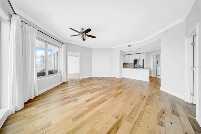 unfurnished living room featuring crown molding, light wood-type flooring, baseboards, and a ceiling fan