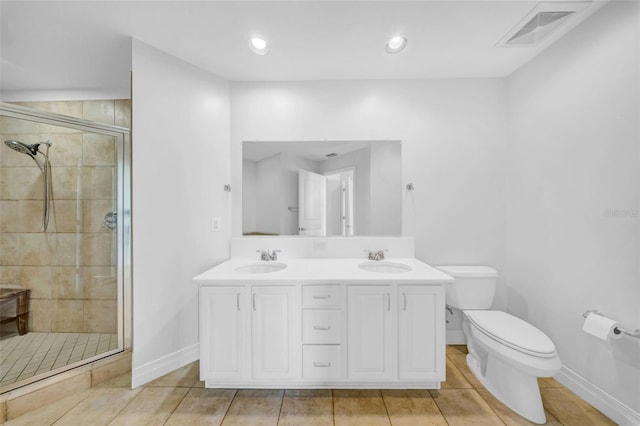 bathroom featuring toilet, visible vents, a shower stall, and a sink