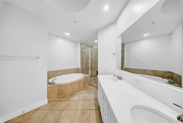 full bathroom with tile patterned floors, a bath, a stall shower, and a sink