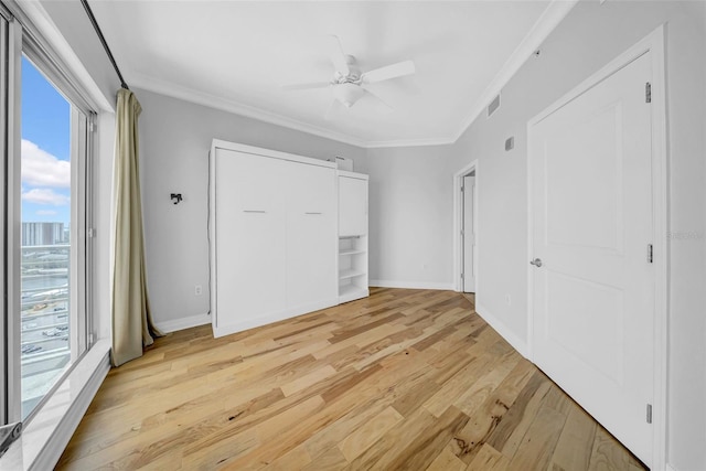 unfurnished bedroom featuring ornamental molding, visible vents, light wood finished floors, baseboards, and access to exterior