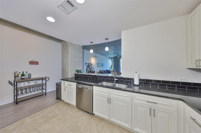 kitchen featuring recessed lighting, dishwasher, visible vents, a sink, and white cabinets