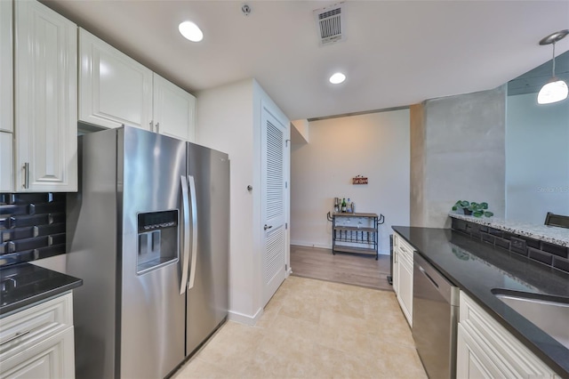 kitchen with pendant lighting, recessed lighting, visible vents, stainless steel appliances, and white cabinets