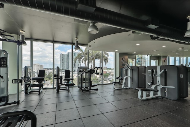 gym featuring a city view and floor to ceiling windows